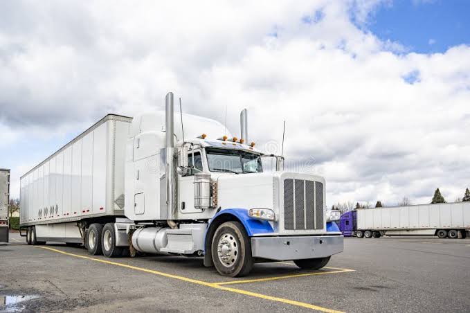 White semi truck with SkidGreen Elite fifth wheel plate installed